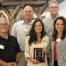 A group photo shows Dr. Johanna Del Castillo Múnera holding a plaque for the 2025 Plant California Alliance Research Award, standing with four colleagues who are smiling and celebrating the recognition.
